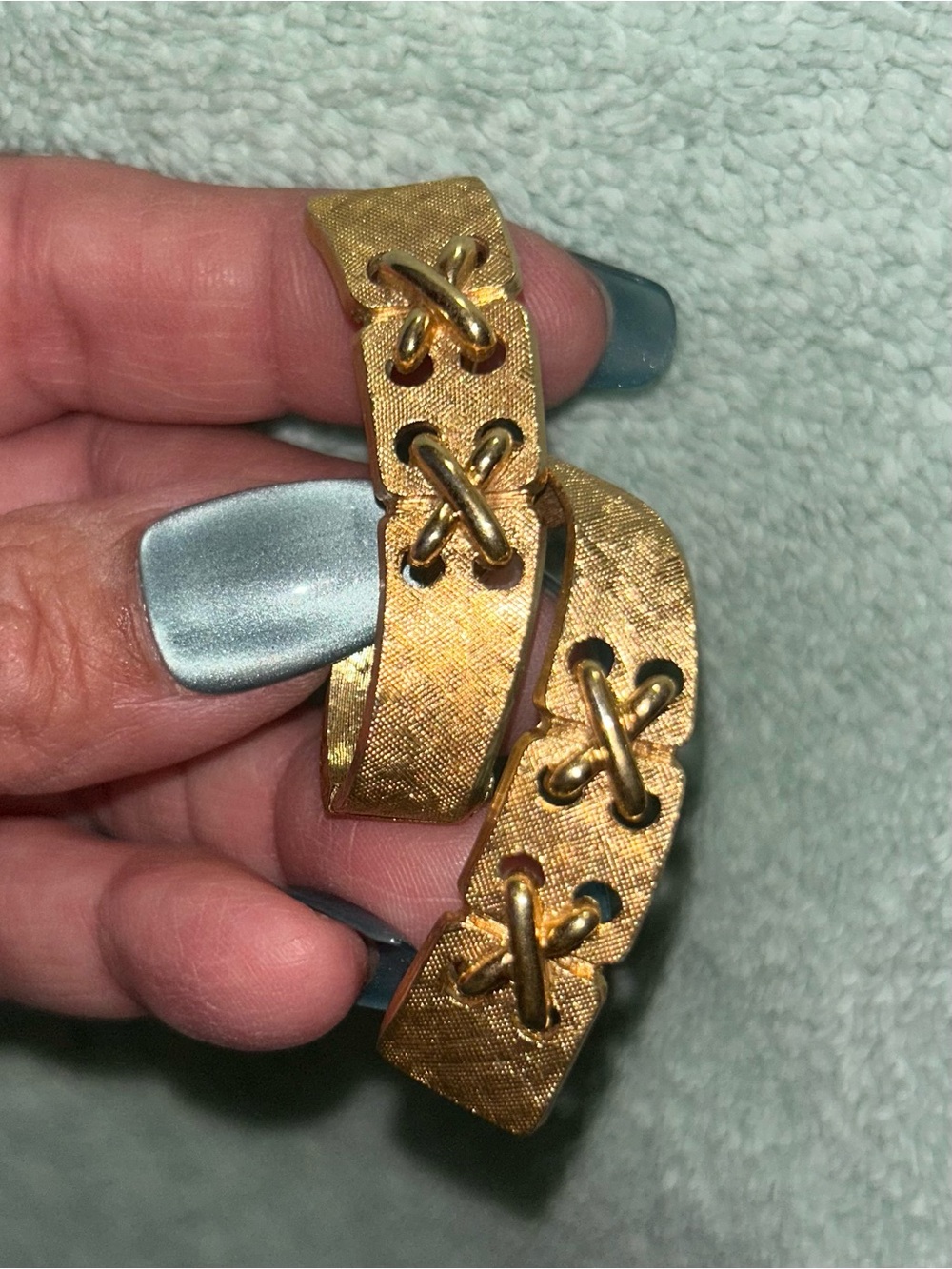 vintage Monet textured gold-tone ribbon "corset" bow brooch.